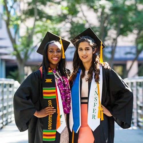 Two female students in graduation garb