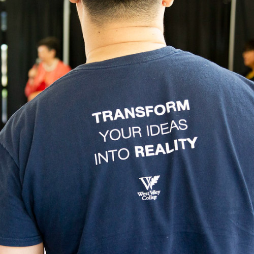 Back of student shirt with text "Transform your dreams into reality"