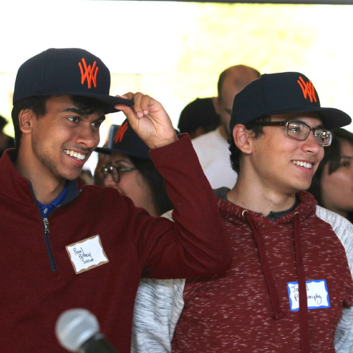 Two students wearing WVC hats